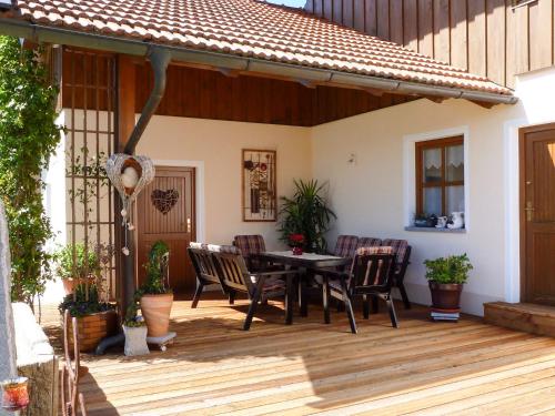 a patio with a table and chairs on a deck at Apartment Freisinger-2 by Interhome in Zachenberg