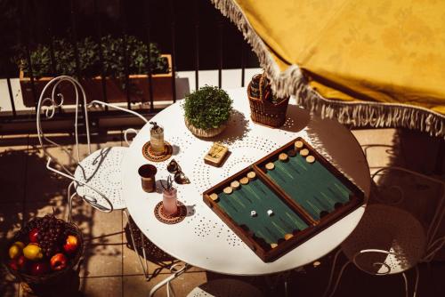 a white table with plants on top of it at Hôtel Monsieur Aristide in Paris