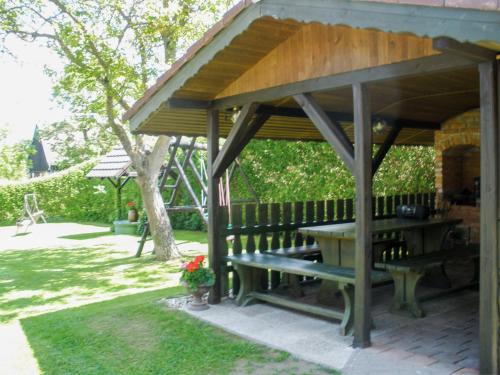 a wooden pavilion with a picnic table and a bench at Holiday Home Haus Polivka by Interhome in Třebíšov