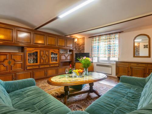 a living room with a couch and a table at Holiday Home Haus Polivka - HUR100 by Interhome in Třebíšov