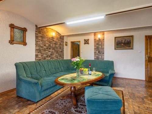 a living room with a green couch and a table at Holiday Home Haus Polivka by Interhome in Třebíšov