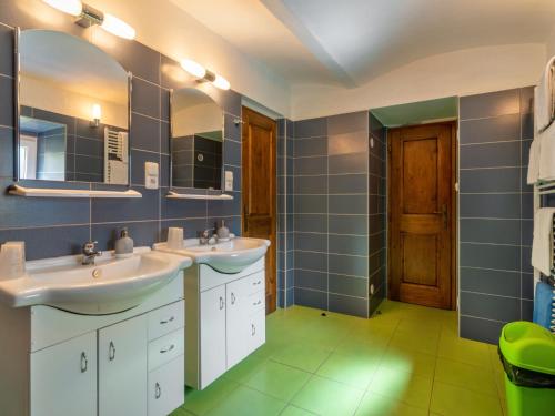 a bathroom with two sinks and two mirrors at Holiday Home Haus Polivka by Interhome in Třebíšov