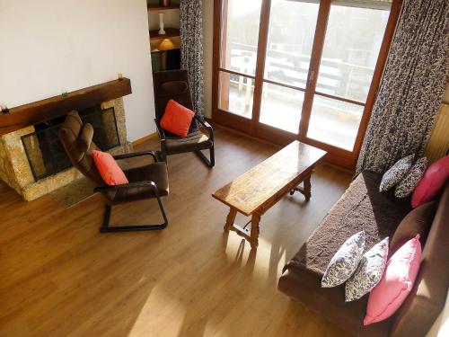 a living room with a couch and chairs and a table at Apartment Villars Soleil A27 by Interhome in Villars-sur-Ollon