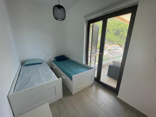 Postel nebo postele na pokoji v ubytování Apartmani Pulić