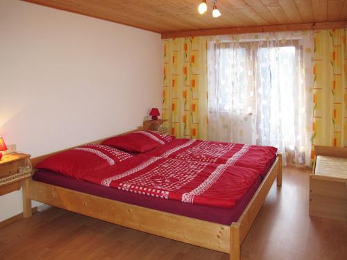 a bedroom with a large red bed in a room at Apartment Gasthof Almluft-6 by Interhome in Stummerberg