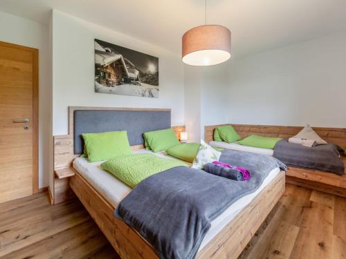two beds in a room with green and blue at Apartment Apart Wurm-2 by Interhome in Stummerberg