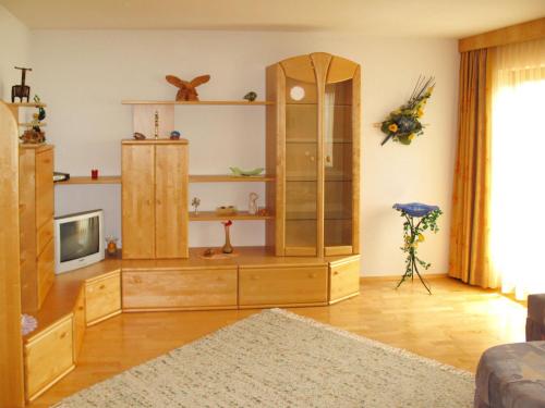 a living room with a large wooden entertainment center at Apartment Wildauer by Interhome in Zellberg