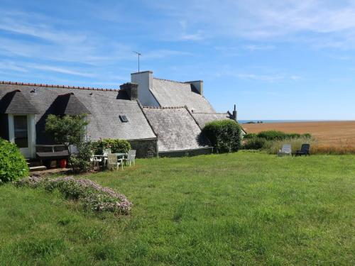 an old house on a field with a grass yard at Holiday Home Les Hortensias - PZV107 by Interhome in Plozévet