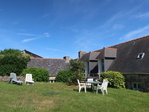 a group of chairs and a table in a yard at Holiday Home Les Hortensias - PZV107 by Interhome in Plozévet