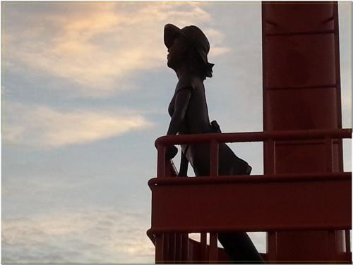 a statue of a woman sitting on a building at Jubilee Chalet in Seogwipo