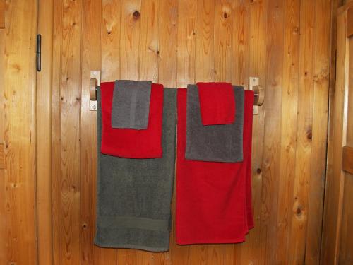 a group of towels hanging on a wooden wall at Chalet Höfli by Interhome in Jaun
