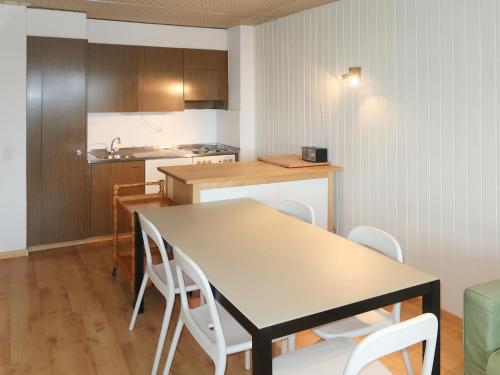 a kitchen and dining room with a table and chairs at Apartment Résidence Velan-24 by Interhome in Les Collons