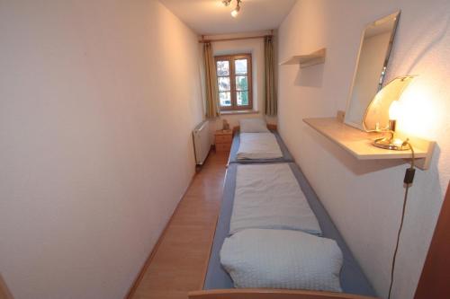 a hallway with three beds in a room at Stanzl Haus in Kaltenbach