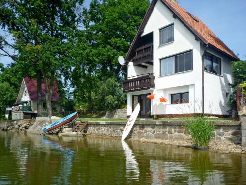 a house with boats in the water in front of it at Chalet Panorama by Interhome in Dehtáře