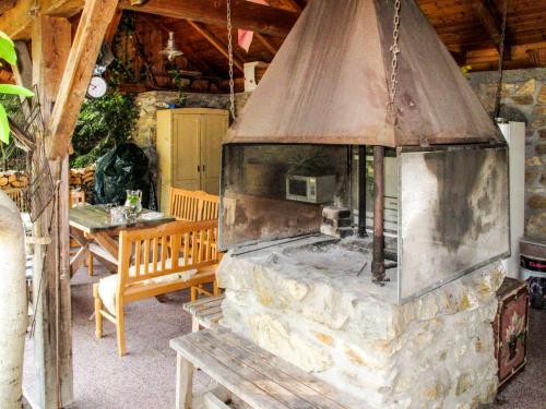 a large stone oven in a patio with a table at Holiday Home Karasova III by Interhome in Dehtáře