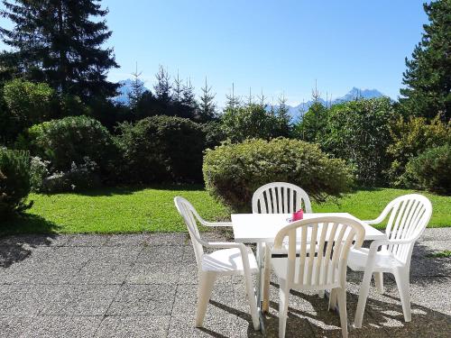 a white table and two chairs sitting next to each other at Apartment Le Mont Blanc 2 by Interhome in Villars-sur-Ollon