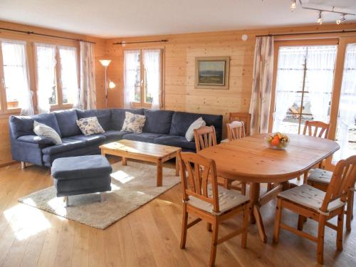 sala de estar con sofá azul y mesa en Apartment ufem Stutz by Interhome, en Grindelwald