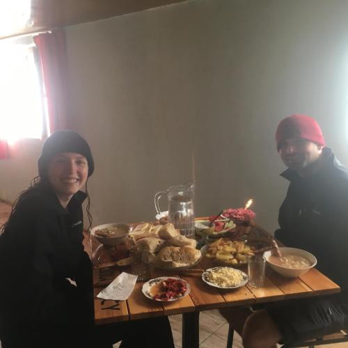 two people sitting at a table with food on it at Sweet home in Lalkhori