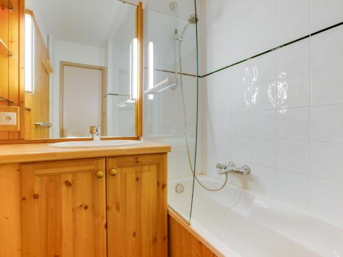 a bathroom with a sink and a glass shower at Apartment Chavière-5 by Interhome in Les Menuires