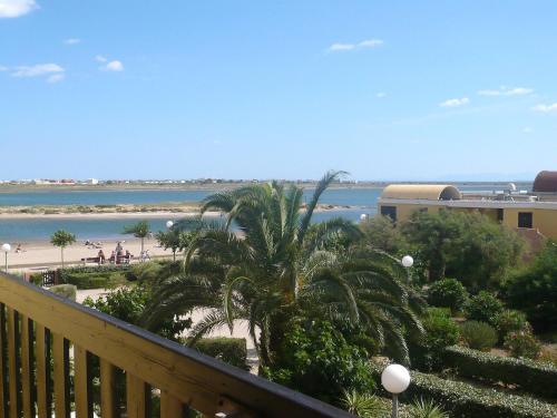 a balcony with a view of a beach and the ocean at Apartment Gruissan Plage by Interhome in Gruissan