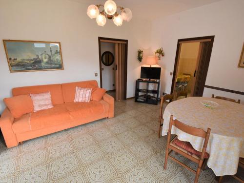 a living room with an orange couch and a table at Apartment Villa Laura-3 by Interhome in Crone