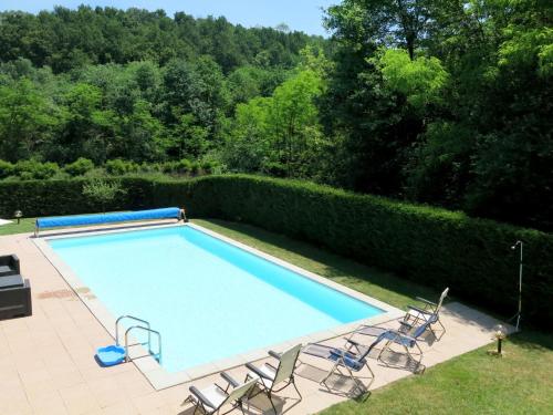 a swimming pool with two chairs at Holiday Home Casa Nocciola by Interhome in Ferrere