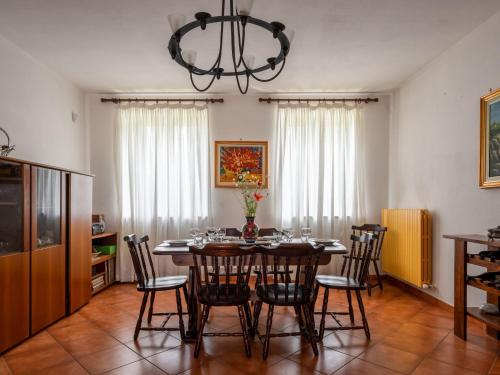 a dining room with a table with chairs and a chandelier at Holiday Home Casa Nocciola by Interhome in Ferrere