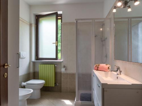 a bathroom with a toilet and a sink and a shower at Holiday Home Casa Nocciola by Interhome in Ferrere