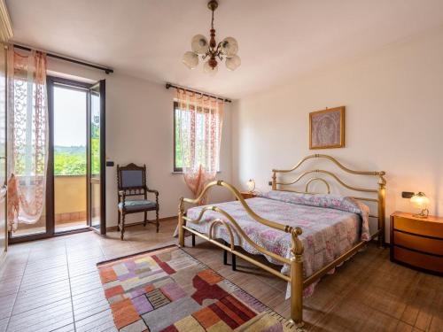a bedroom with a bed and a chair and a window at Holiday Home Casa Nocciola by Interhome in Ferrere