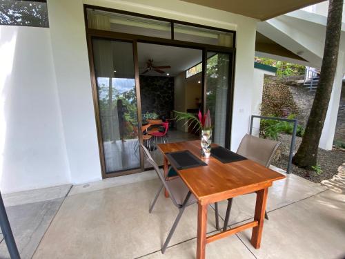 a wooden table and chairs on a patio at Casa Libertinn in Manuel Antonio