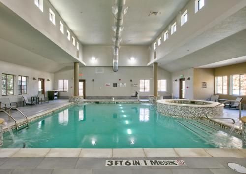a large swimming pool in a large room with a pool at Staybridge Suites Plano - Richardson Area by IHG in Plano