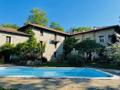 a house with a swimming pool in front of it at Mulino Gorretta Langhe House with swimming pool in Torre Bormida