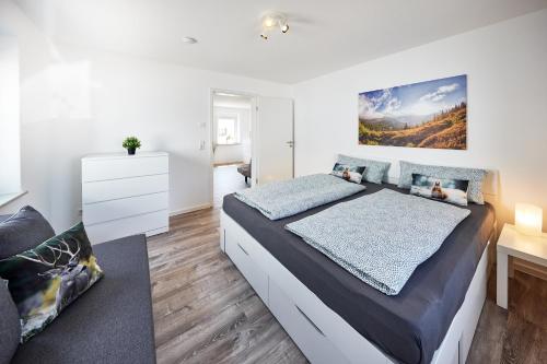 a bedroom with a large bed and a desk at Wohnung 14 - ohne Auto in den Europa-Park in Ringsheim