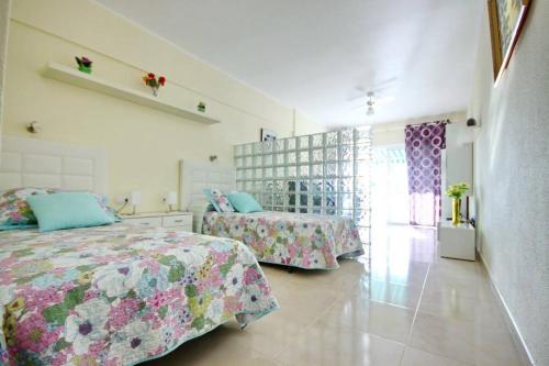 a bedroom with two beds and a window at Studio in beachfront complex in El Duque area, Costa Adeje in Adeje