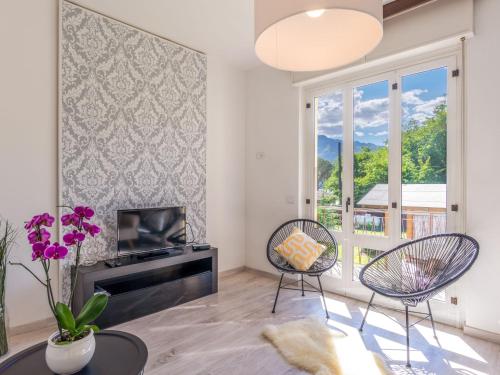 sala de estar con TV, sillas y ventana en Holiday Home Villa Zaferina - CCO113 by Interhome, en Carriola