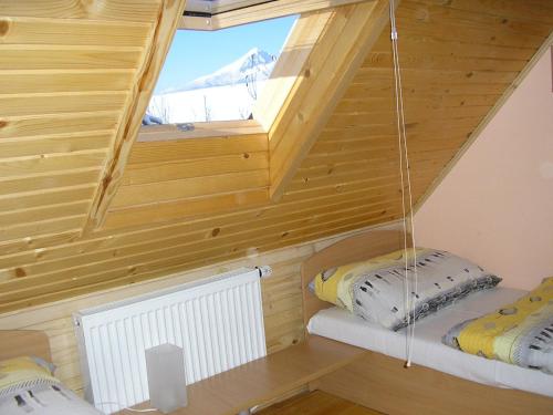 a room with two bunk beds and a window at Mária Kičáková TATRY MKS in Štrba