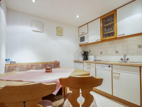 a kitchen with a table and two chairs in it at Apartment Christian by Interhome in Pettneu am Arlberg