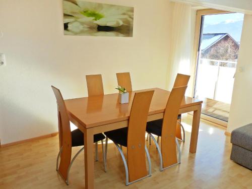 a wooden dining room table with four chairs at Apartment Schallhart by Interhome in Terfens