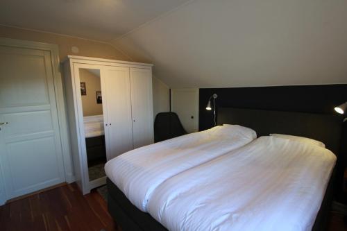 a bedroom with a large bed with white sheets at At Home Bed & Breakfast in Gothenburg