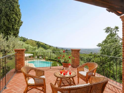 a patio with chairs and a table and a pool at Holiday Home Villa I Cipressi by Interhome in Nievole