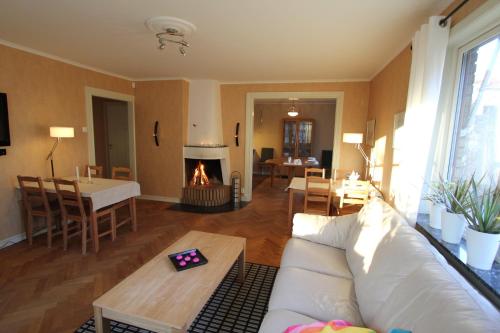 a living room with a couch and a fireplace at At Home Bed & Breakfast in Gothenburg