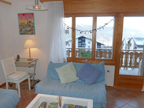 a living room with a couch and a table at Apartment Ambassador I Apt 7 by Interhome in Nendaz
