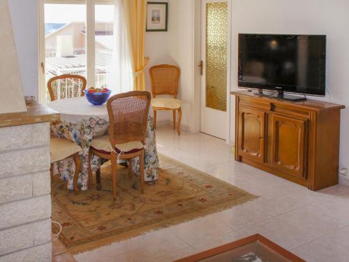 A television and/or entertainment centre at Holiday Home Papagayo by Interhome