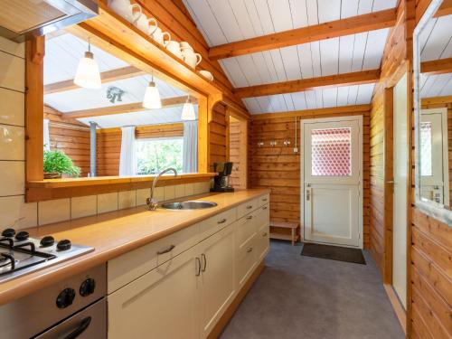 a kitchen with a sink and a stove at Holiday Home Rusthoeve 14 by Interhome in Sint Maartensvlotbrug