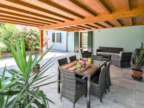 an outdoor patio with a wooden table and chairs at Holiday Home Azienda Agricola Forzello-1 by Interhome in San Basilio