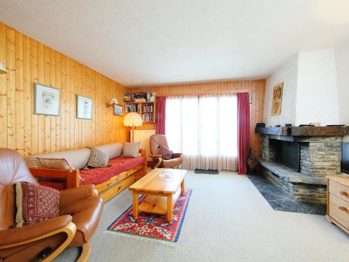 a living room with a couch and a fireplace at Apartment Sapin Bleu 6 by Interhome in Villars-sur-Ollon