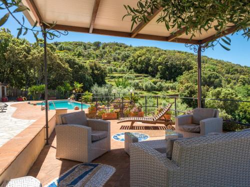 a patio with chairs and a swimming pool at Villa Ricali by Interhome in Porto Santo Stefano