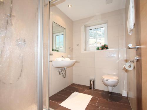a bathroom with a shower and a sink and a toilet at Apartment Pfeifer-1 by Interhome in Pians