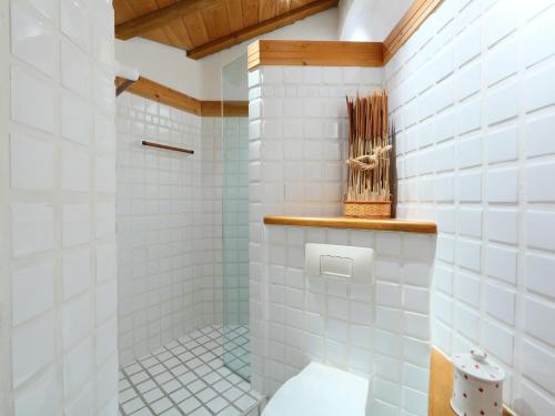 a bathroom with a shower with white tiles at Holiday Home Les Clèves by Interhome in Nendaz