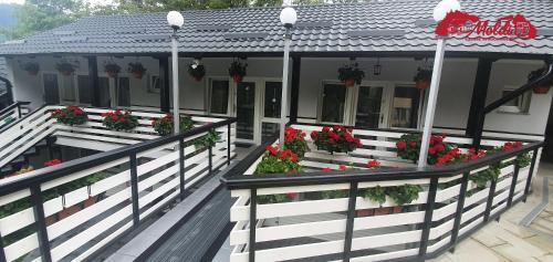 a house with flower boxes on the balcony at Cazare Moldi Btt in Câmpulung Moldovenesc
